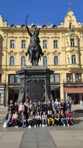 grupowe zdjęcie uczniów pod pomnikiem